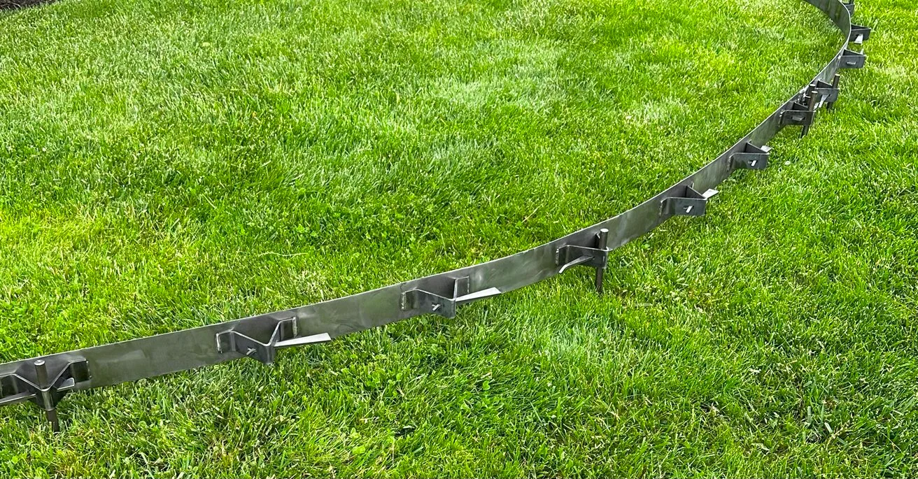 Flexible flatwork concrete form set in a curve on grass